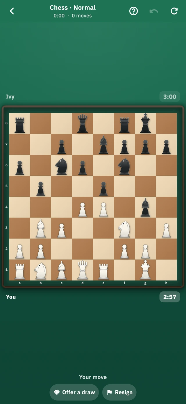 A game of chess against the computer, the pieces set out on a wooden board with the file and rank labels along the edges.